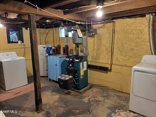 basement with electric water heater and washing machine and clothes dryer