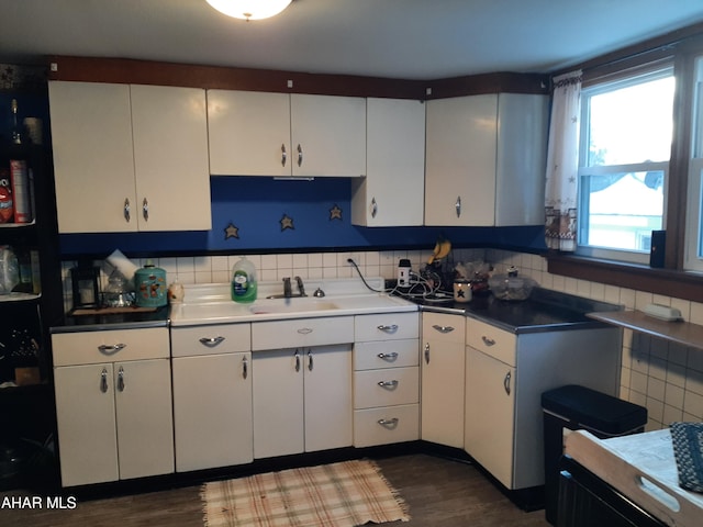 kitchen with white cabinetry, sink, and dark hardwood / wood-style flooring