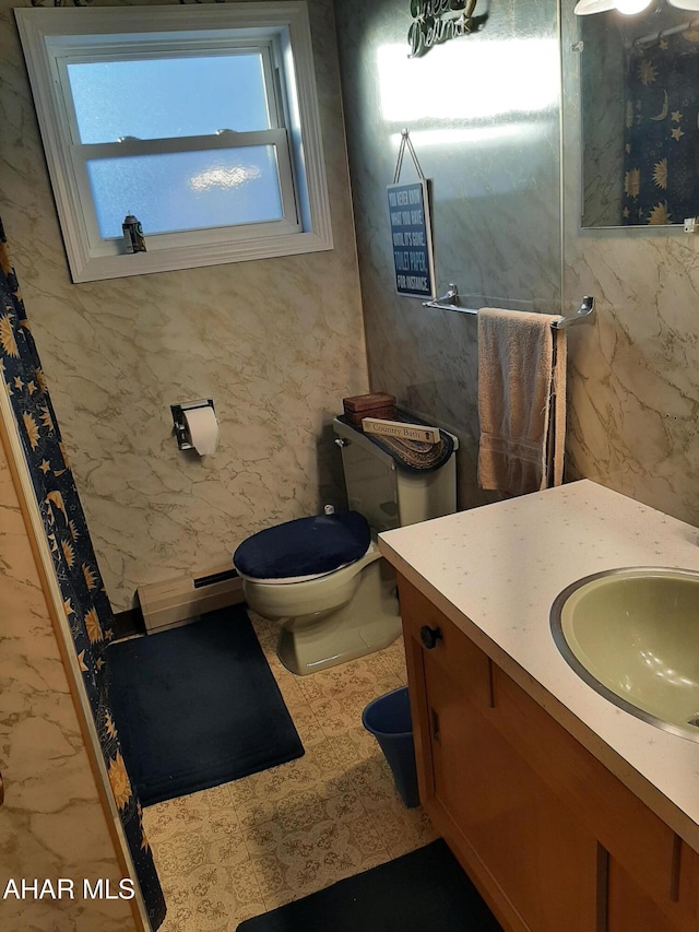 bathroom with vanity, a baseboard radiator, and toilet