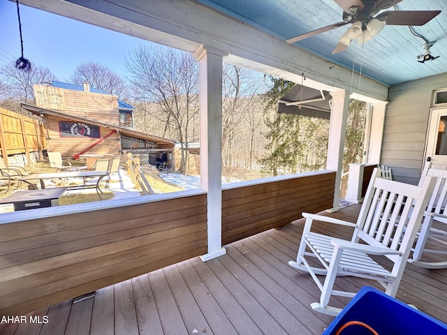 wooden deck featuring ceiling fan and fence