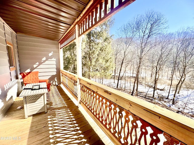 view of snow covered back of property