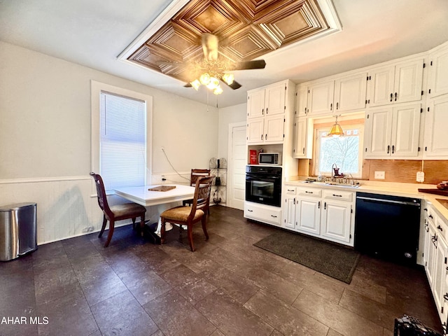 kitchen featuring black appliances, white cabinetry, and light countertops