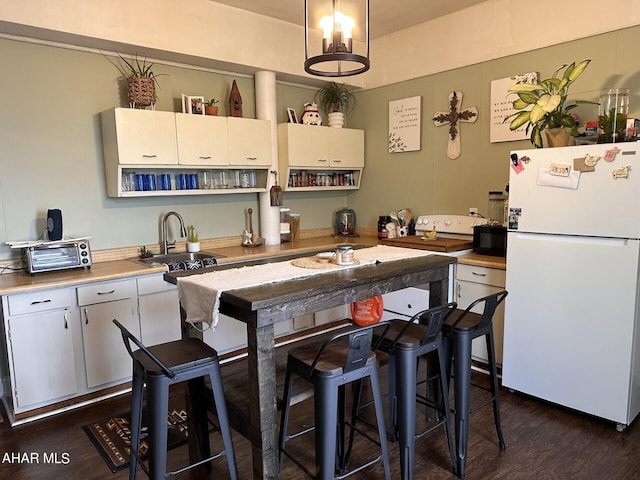 321 Main St, Gallitzin, PA 16641 - kitchen with a sink, freestanding refrigerator, light countertops, dark wood-style floors, and electric stove