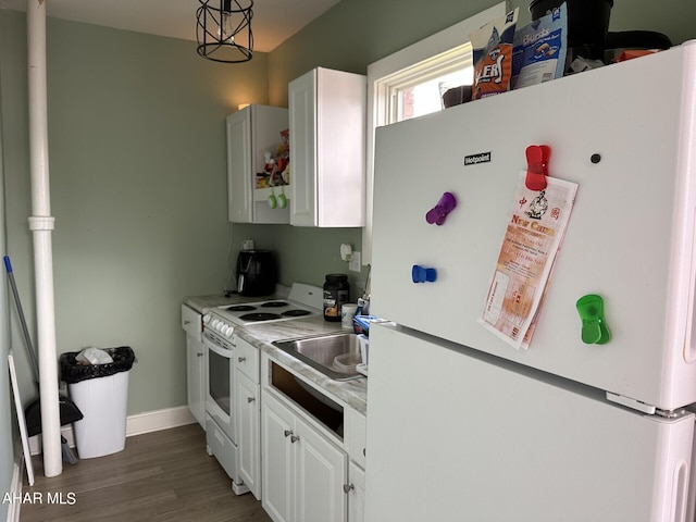 321 Main St, Gallitzin, PA 16641 - kitchen featuring a sink, white appliances, wood finished floors, light countertops, and white cabinets