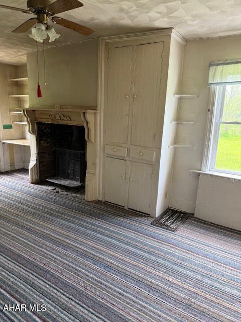 3091 Colonial Dr, Duncansville, PA 16635 - unfurnished living room with carpet flooring, a ceiling fan, and a fireplace