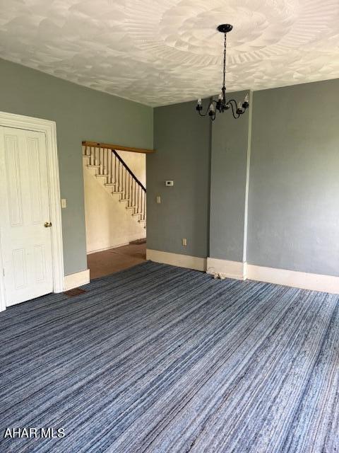 3091 Colonial Dr, Duncansville, PA 16635 - unfurnished room featuring stairway, baseboards, a chandelier, carpet, and a textured ceiling