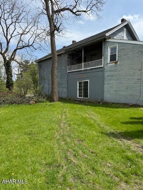 3091 Colonial Dr, Duncansville, PA 16635 - rear view of property with a lawn, a chimney, and a balcony