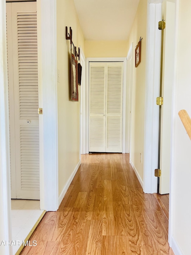 corridor with light hardwood / wood-style floors