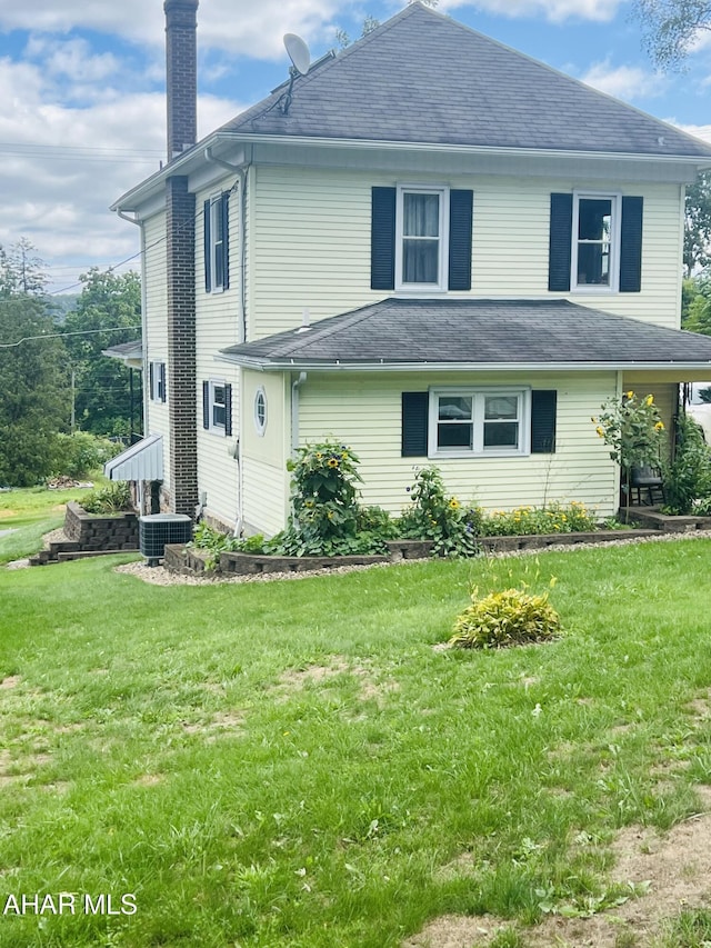 exterior space featuring a lawn and cooling unit