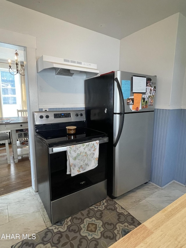 523 W 16th St, Tyrone, PA 16686 - kitchen with appliances with stainless steel finishes, a chandelier, under cabinet range hood, and light marble finish floors