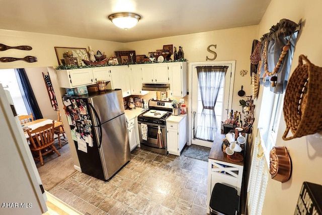 1809 5th St, Altoona, PA 16601 - kitchen featuring gas stove, freestanding refrigerator, under cabinet range hood, and healthy amount of natural light