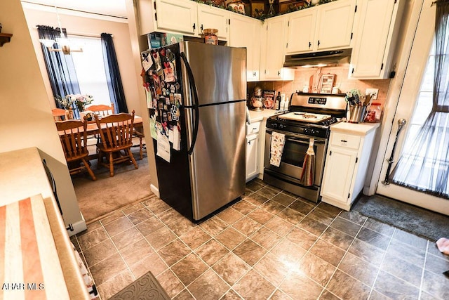 1809 5th St, Altoona, PA 16601 - kitchen featuring appliances with stainless steel finishes, under cabinet range hood, light countertops, white cabinets, and decorative backsplash