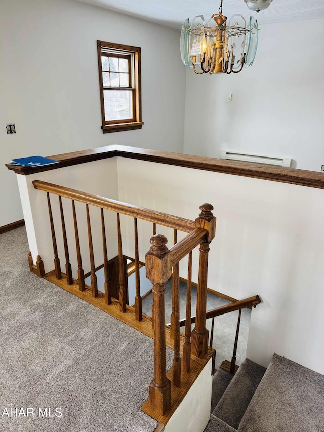 stairs featuring a notable chandelier and carpet floors