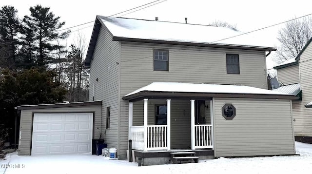 view of front property with a garage and a porch