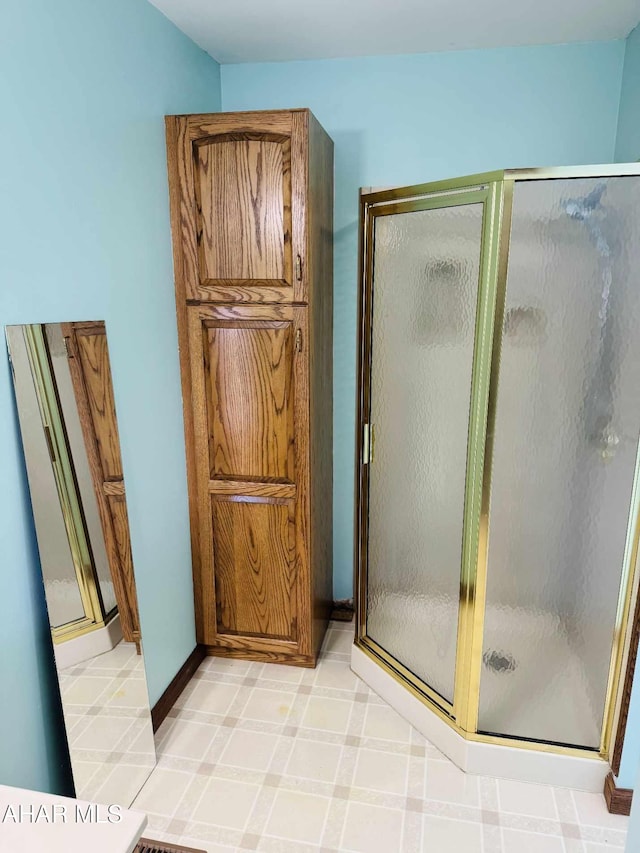 bathroom featuring a shower with shower door