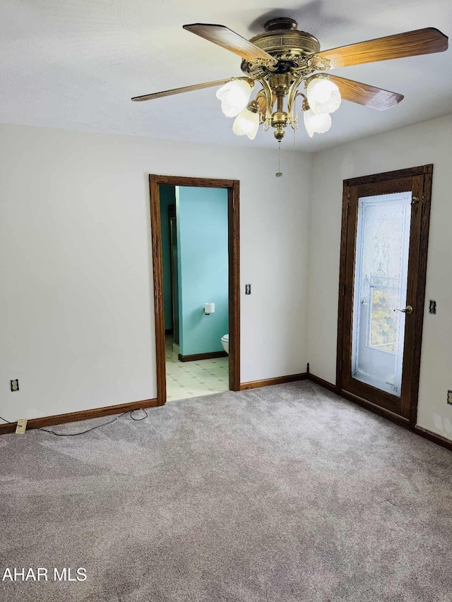 empty room with ceiling fan and light carpet