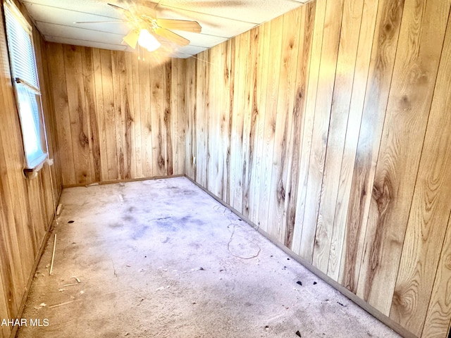 unfurnished room featuring wood walls