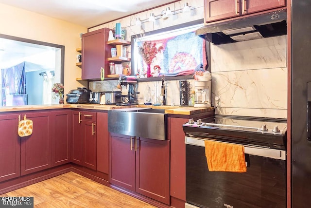 kitchen featuring wood counters, tasteful backsplash, and light hardwood / wood-style floors