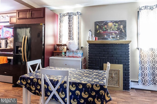 dining room with a fireplace and light wood-type flooring