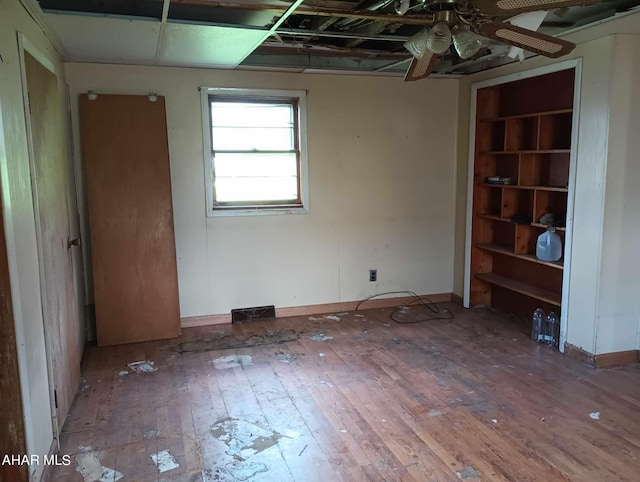 spare room with ceiling fan and wood-type flooring