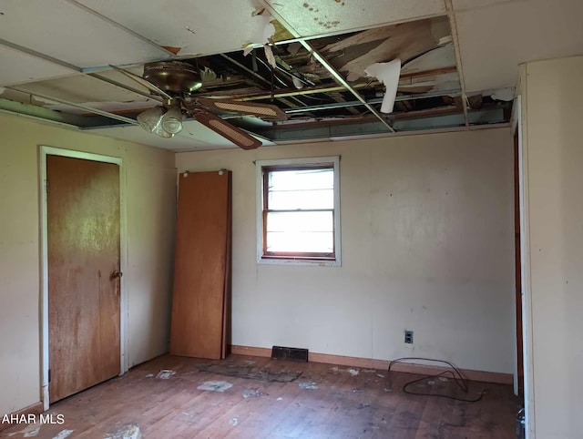 unfurnished bedroom featuring ceiling fan and hardwood / wood-style floors