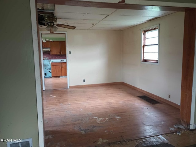 empty room featuring ceiling fan and light hardwood / wood-style floors