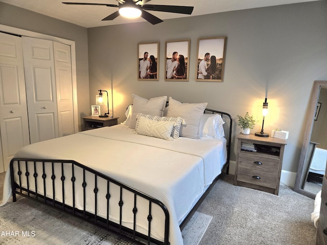 carpeted bedroom featuring a closet and ceiling fan