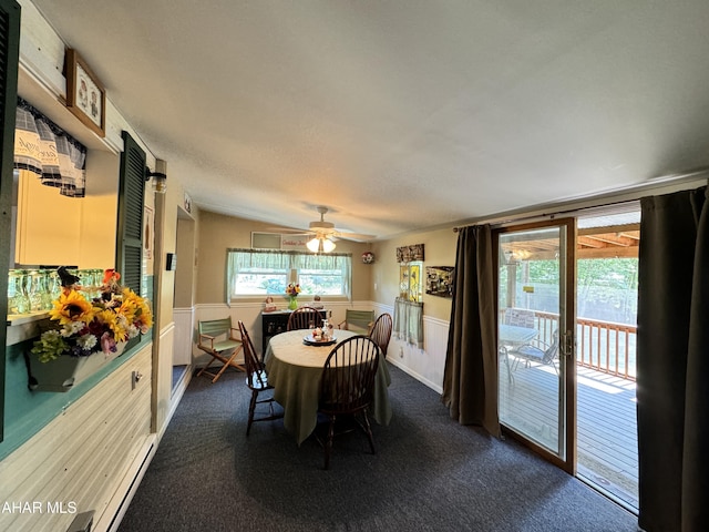 carpeted dining space featuring ceiling fan and lofted ceiling