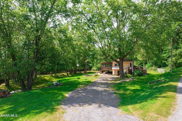 view of front facade featuring a deck and a front lawn