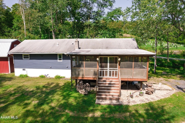 back of property featuring a yard and a sunroom