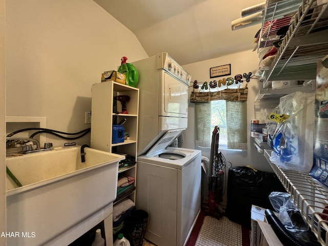 laundry room with stacked washer / drying machine and sink