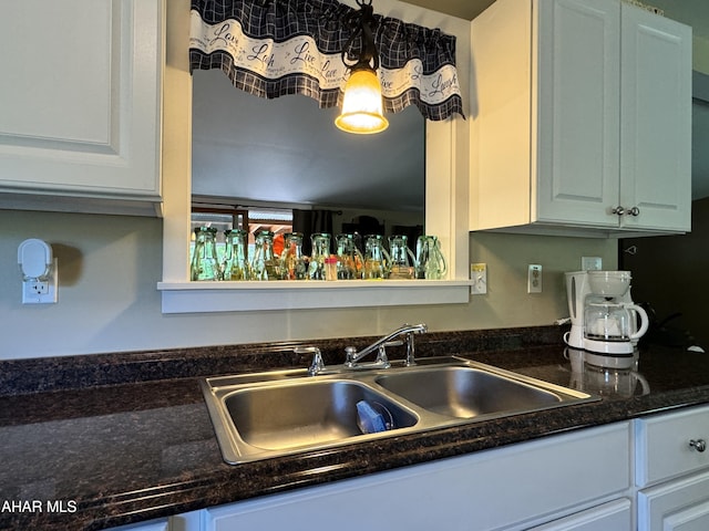 kitchen featuring white cabinetry and sink