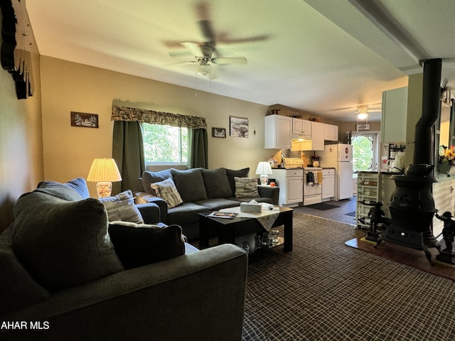 living room with ceiling fan and dark carpet