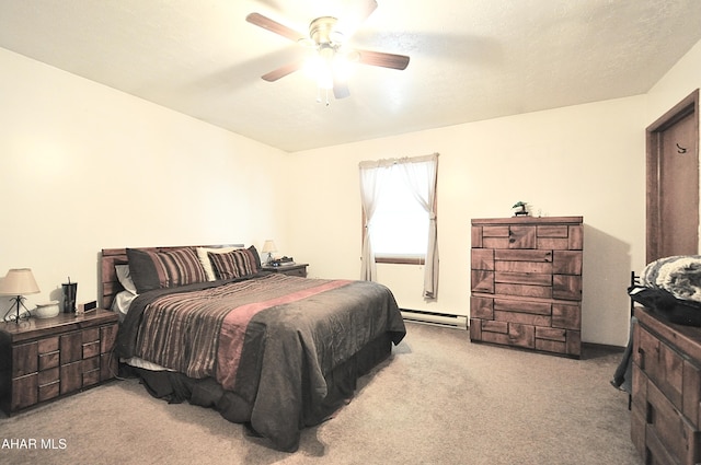 carpeted bedroom featuring baseboard heating and ceiling fan