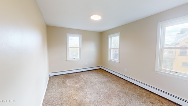 unfurnished room featuring carpet flooring, a baseboard heating unit, and baseboards