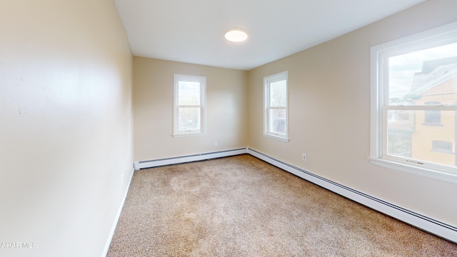 carpeted spare room featuring a baseboard radiator and baseboards