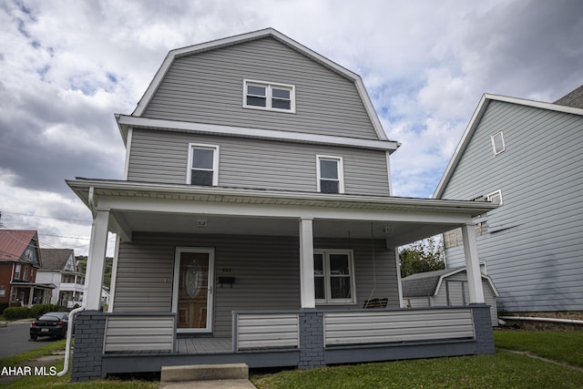 view of front of property featuring a porch and a gambrel roof