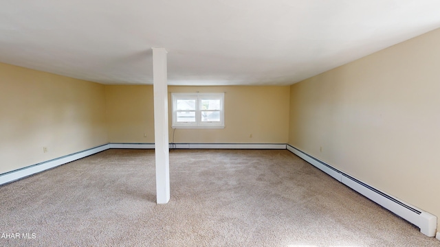 basement featuring a baseboard radiator, baseboards, and carpet floors