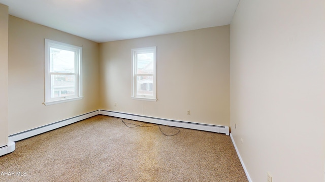 carpeted spare room featuring a baseboard radiator and baseboards