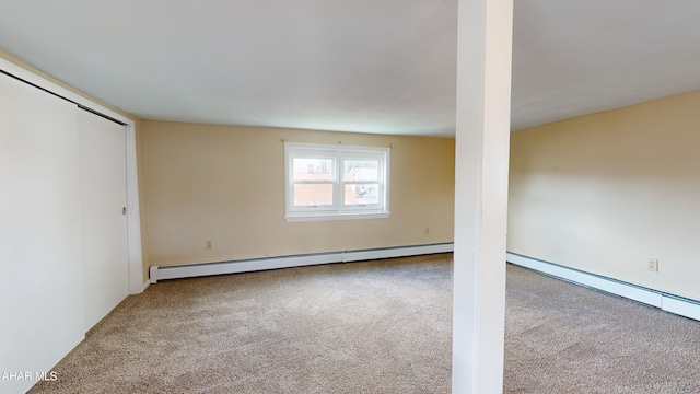below grade area with carpet flooring and baseboard heating