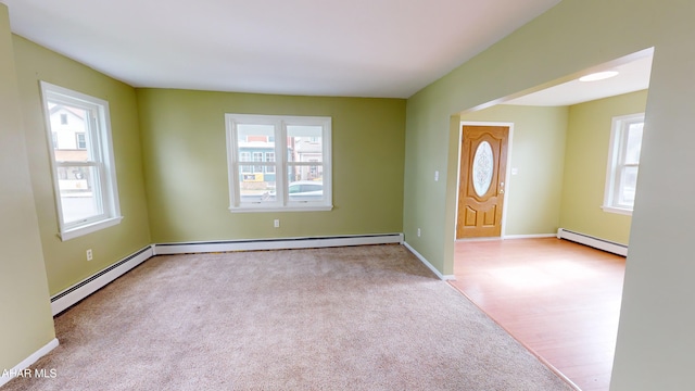 foyer with a wealth of natural light and baseboard heating
