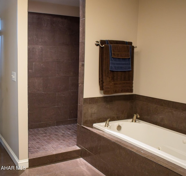 bathroom featuring tile patterned flooring and separate shower and tub