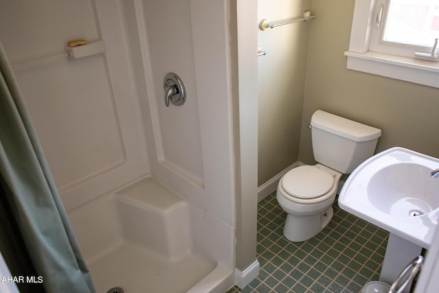 bathroom with toilet and walk in shower