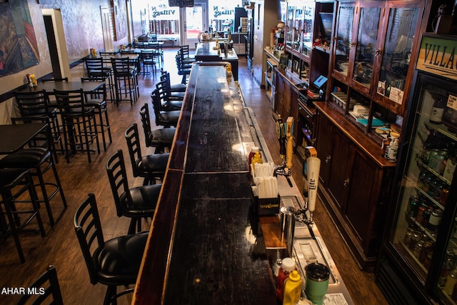 bar with hardwood / wood-style floors