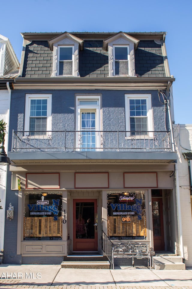 view of front of house featuring a balcony