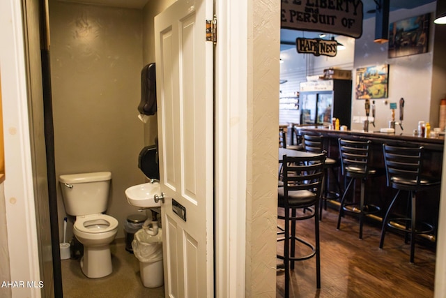 bathroom with sink, wood-type flooring, and toilet