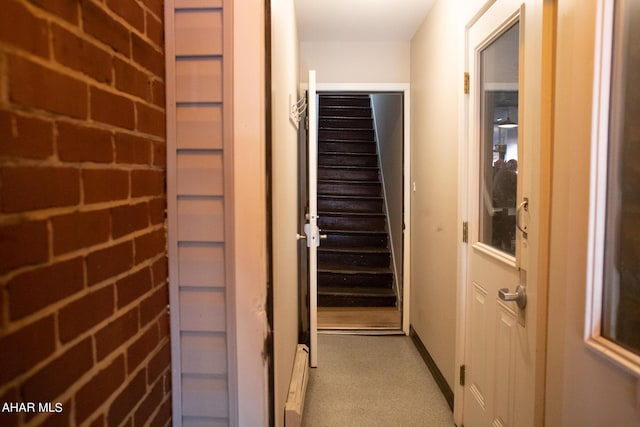 hallway featuring brick wall