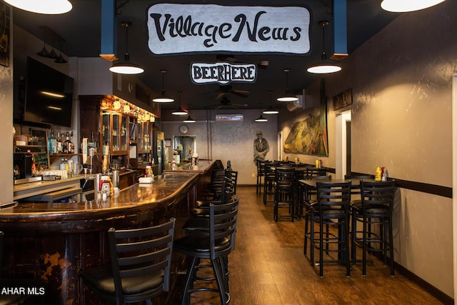 bar with hardwood / wood-style flooring