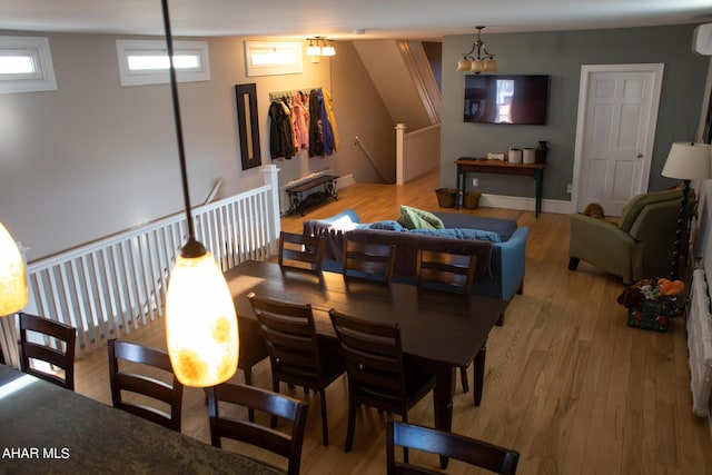 living room featuring light hardwood / wood-style floors and a wall unit AC