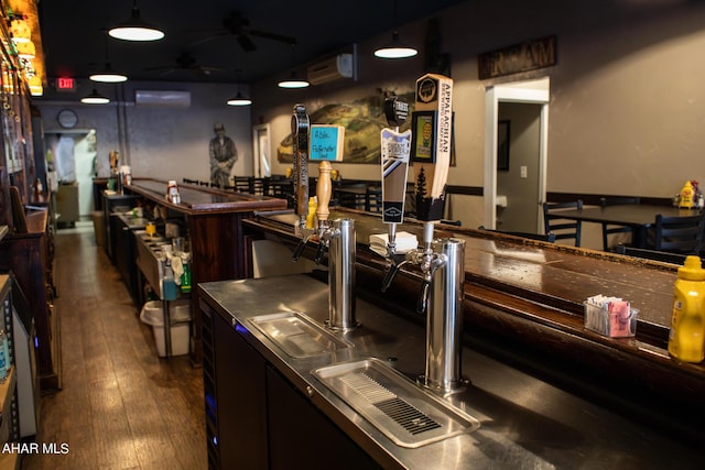 bar featuring a wall mounted AC, ceiling fan, dark wood-type flooring, and decorative light fixtures